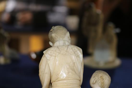 A Japanese ivory group of two figures with basket of oranges height 16cm